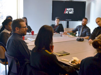 Group of students sitting around a large table discuss the arts with Pedro Reyes, CAST Visiting Artist.