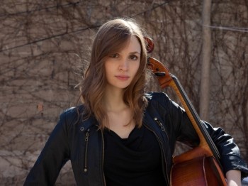 A woman poses with a cello.