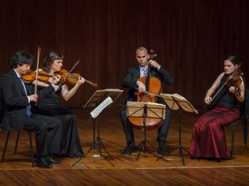 A string quartet performs.
