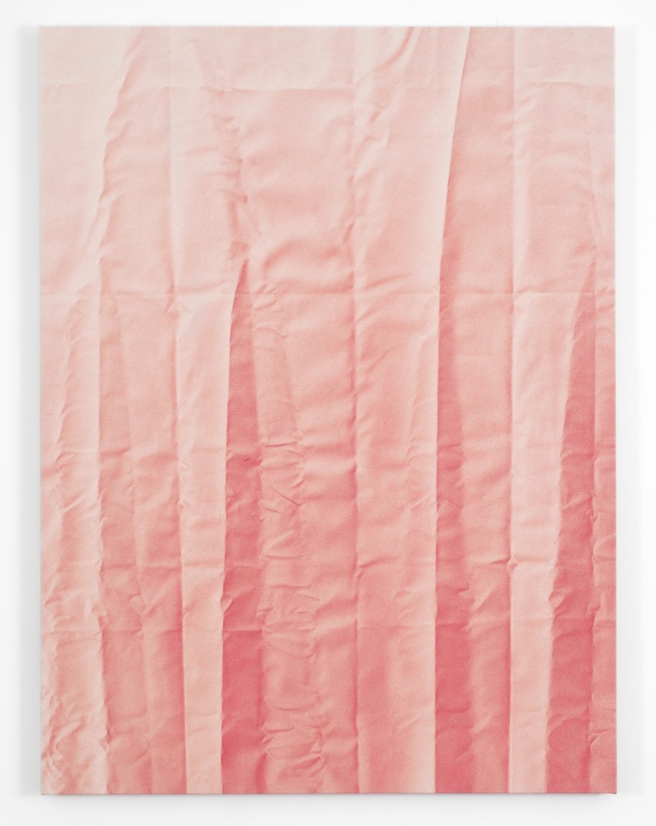 A pastel pink wrinkled piece of fabric.