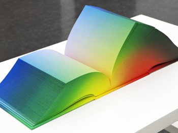 A large multi-colored book with no words.