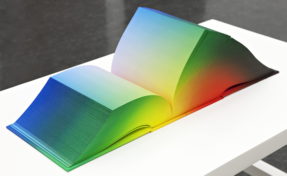 A large multi-colored book with no words.