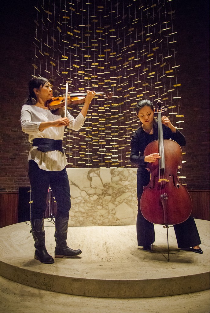 Two women perform cello and violin.
