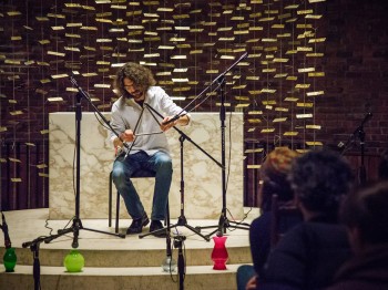 A man performs triangle in front of a marble altar