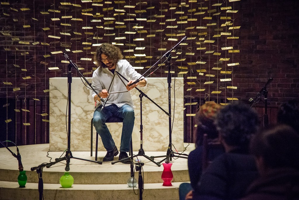 A man performs triangle in front of a marble altar