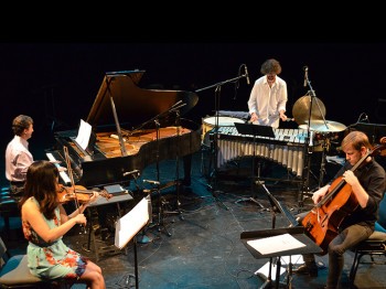 Four musicians perform piano, violin, cello, and vibraphone