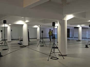 A gallery with many speakers on tripods.
