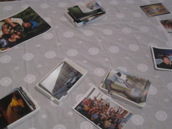 A collection of photographs in trays on a table.