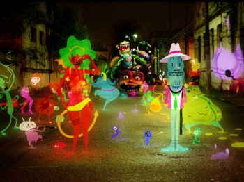 Colorful animated figures of humans and animals on a photograph of an empty street