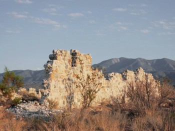 A crumbling stone wall in an arid landscape