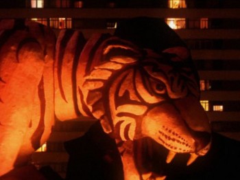 Orange light illuminates a sculpture of a tiger