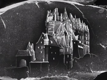 Microscope image of a castle etched on a stony object