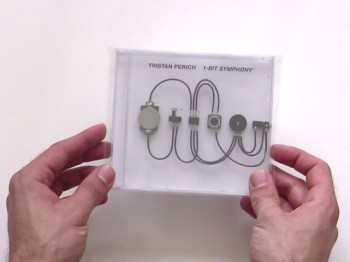Hands hold a CD case depicting small chips connected by wires