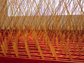 Close up of a large object made of wooden boards, rods, and sticks