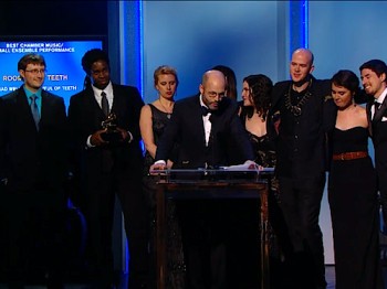 A group of people stand on a stage to accept an award.