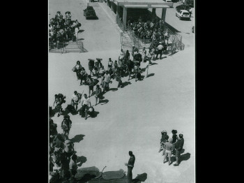 A black and white photograph of a line of people.