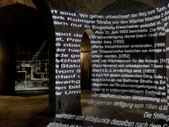 German words projected on brick arches.