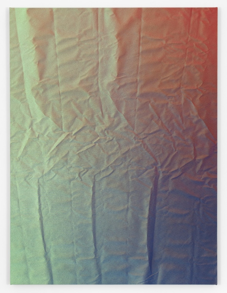 A pastel multi-colored wrinkled piece of fabric.