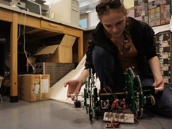 A student works with a robotic device in a laboratory.