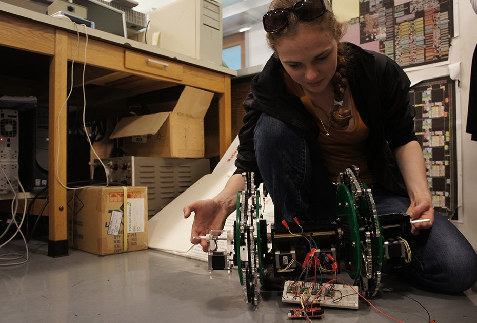 A student works with a robotic device in a laboratory.