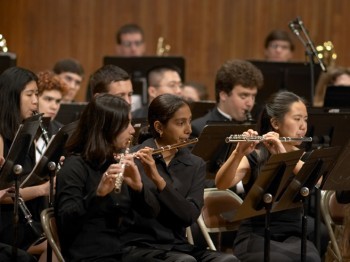 A student wind ensemble performs.