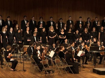 A large choir performs with a chamber ensemble.