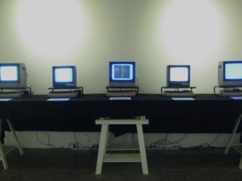 A row of five small old computers.