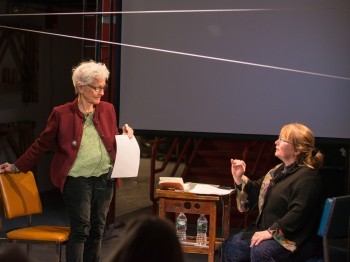 Two women on a stage.