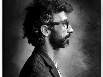Black and white side profile portrait of Karim Ben Khelifa.