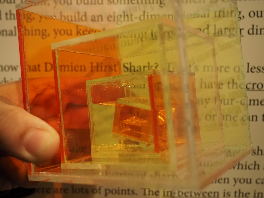Orange and yellow glass boxes in front of a page of text.