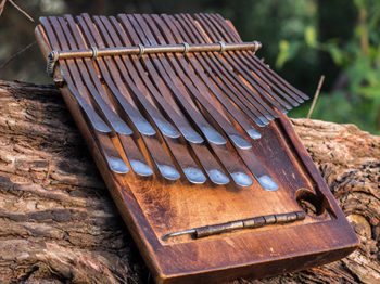 A mbira, created using the wood of a Mubvamaropa tree and staggered metal tines, is played by holding the instrument in the hands and plucking the tines with the thumbs. Fradreck Mujuru specializes in making the mbira in Dambatsoko tuning, which has been played by the Mujurus for generations.