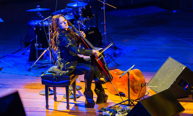 Maya Beiser performs cello on stage.