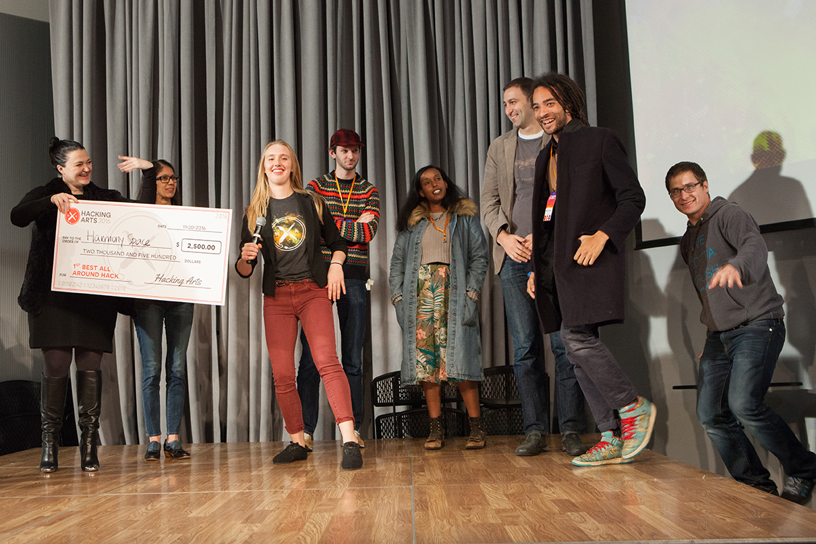 Team Harmony, Max Harper, Matthew Seaton, Evin Huggins, accepts 1st prize for best all-around hack with judges Nick Meyer, Salome Asega, Mitch Sinclair and Daniel Doubrovkine, Hacking Arts 2016. Photo: Dana Tarr Photography.