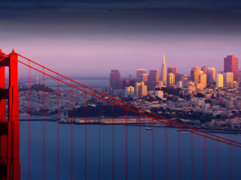 The Golden Gate Bridge with San Francisco skyline in the background.