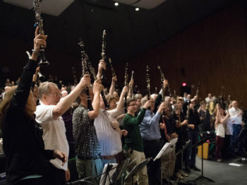 Clarinetists play along in the audience at the Great Clarinet Summit. Credit Sham Sthankiya.