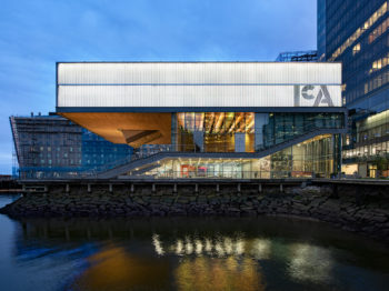 A geometric, modern building with "ICA" logo on a waterfront.