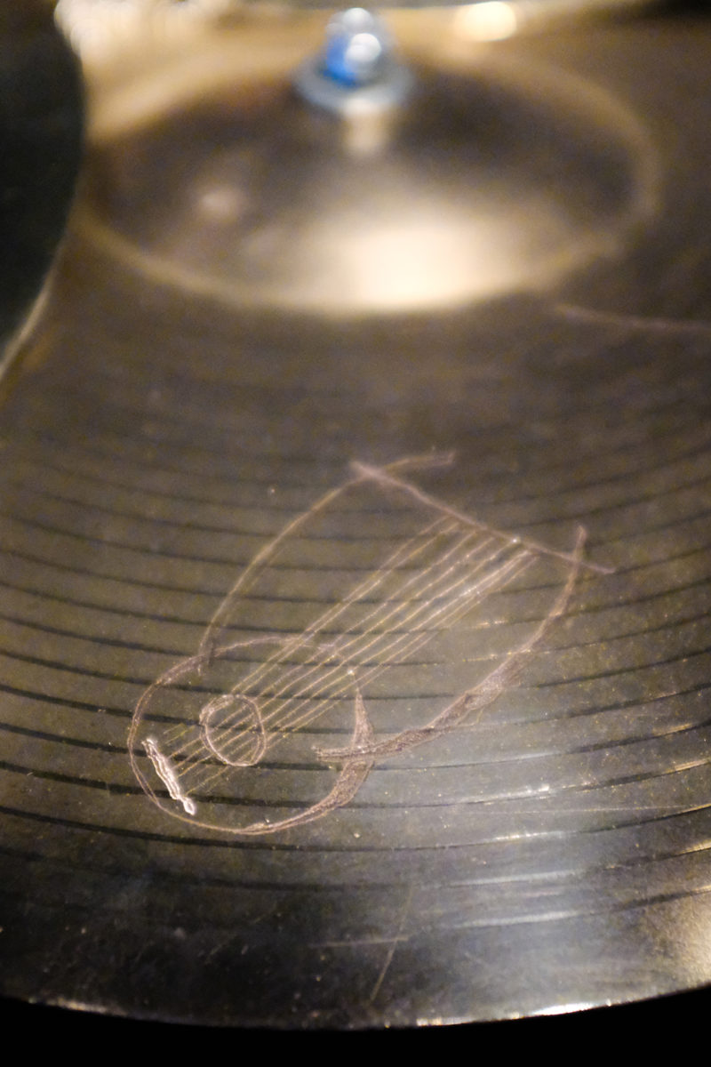 Close up view of bronze cymbals engraved with illustrations.