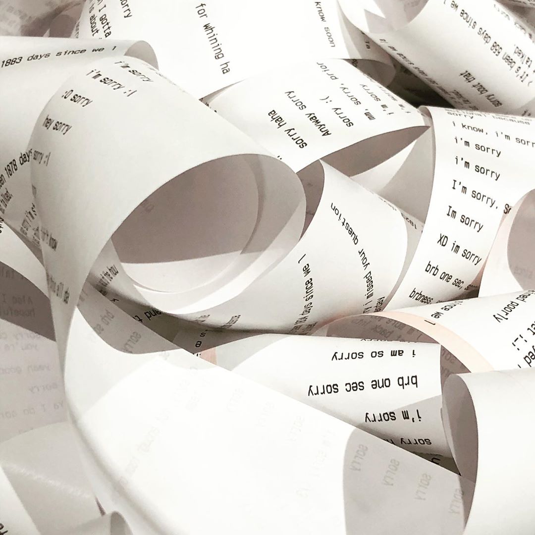 Closeup image of rolls of receipt paper. Various messages containing the word "sorry" are printed on the receipts.