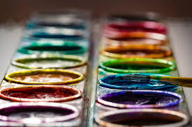 Close up view of a watercolor palette with brush.