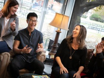 Four people participating and laughing at The Laughing Room.