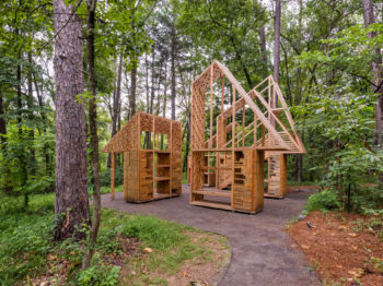 View of the Totem House installation in a forest.