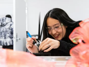 Student in protective goggles in the Introduction to Physical Computing for Artists.
