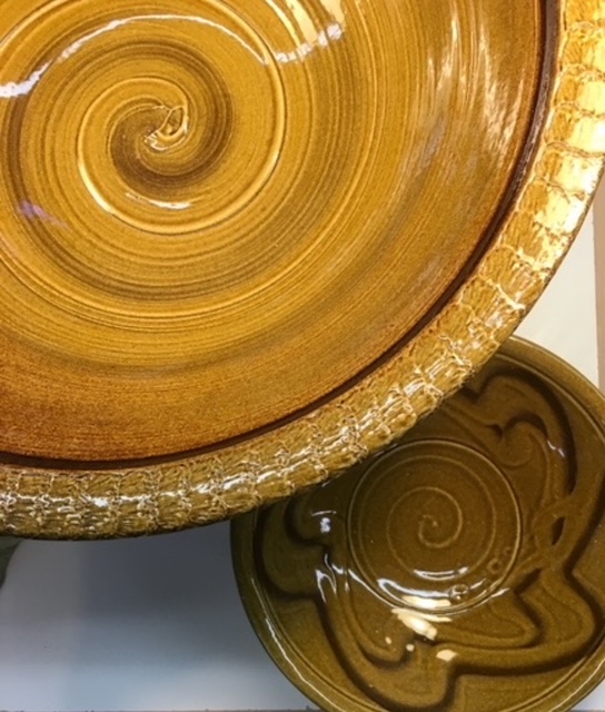 Overhead looking down color photograph of glazed ceramics bowls in Klinesville Gold.