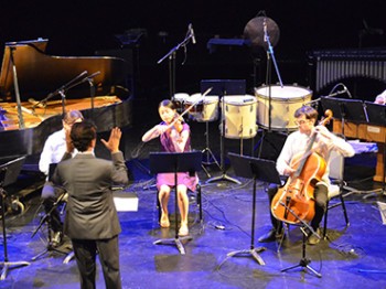A group of musicians perform on stage.