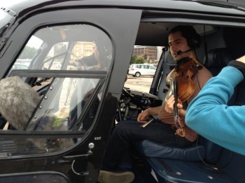 A man plays viola in a helicopter.