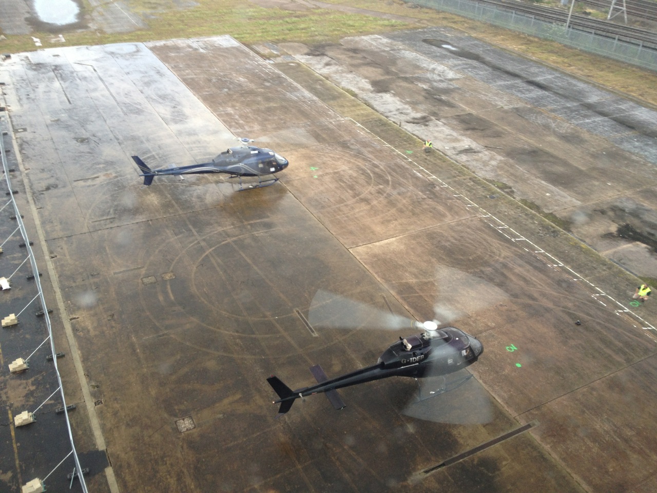 Two helicopters on a landing strip.