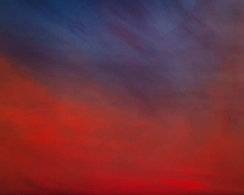 A blue and red cloudy sky.