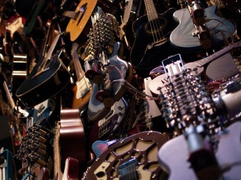 A pile of guitars and guitar technology.