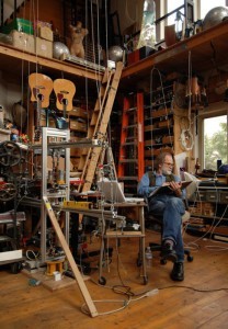 A man in an instrument-making studio.